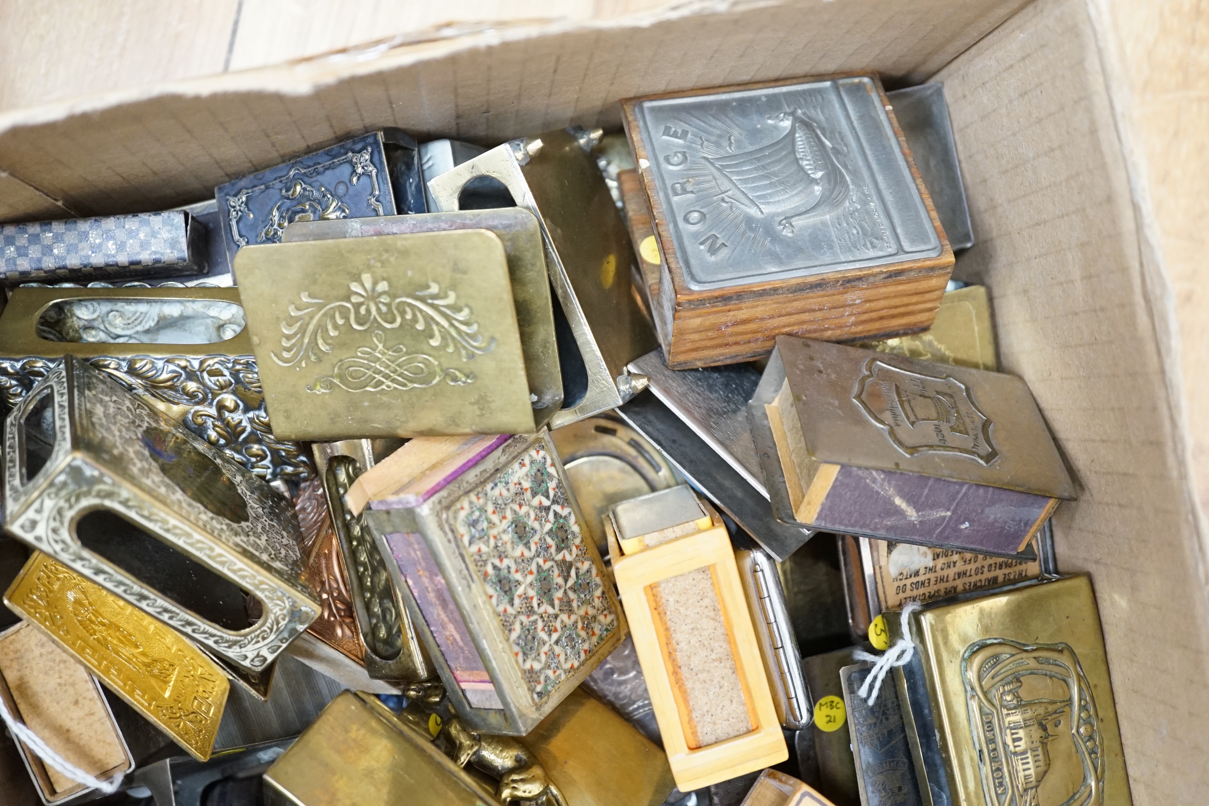 Two boxes of mixed metal matchbox holders including brass and copper